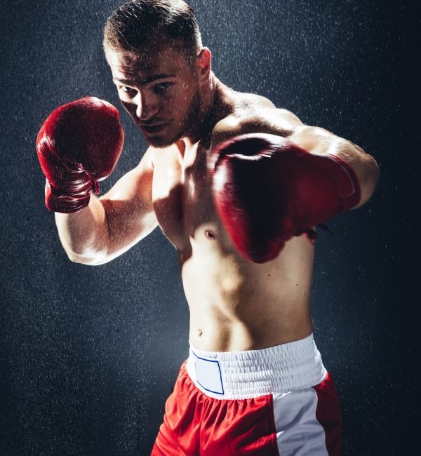 Boxing man ready to fight in the rain.